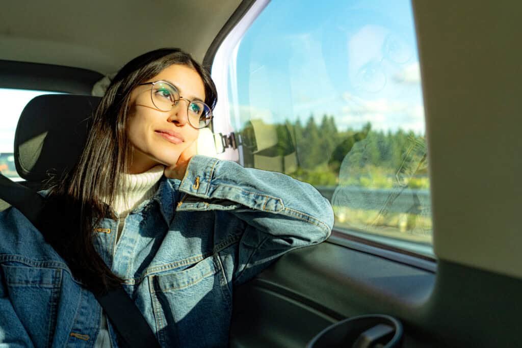 Passenger seated comfortably in the back of a taxi, enjoying a safe and relaxed journey